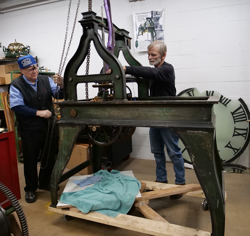 Richard Whitmore and Reggie Riddle working on the clock