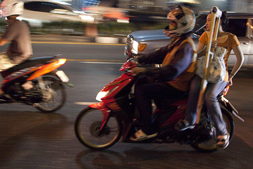 woman with broken leg riding bangkok motorcycle taxi