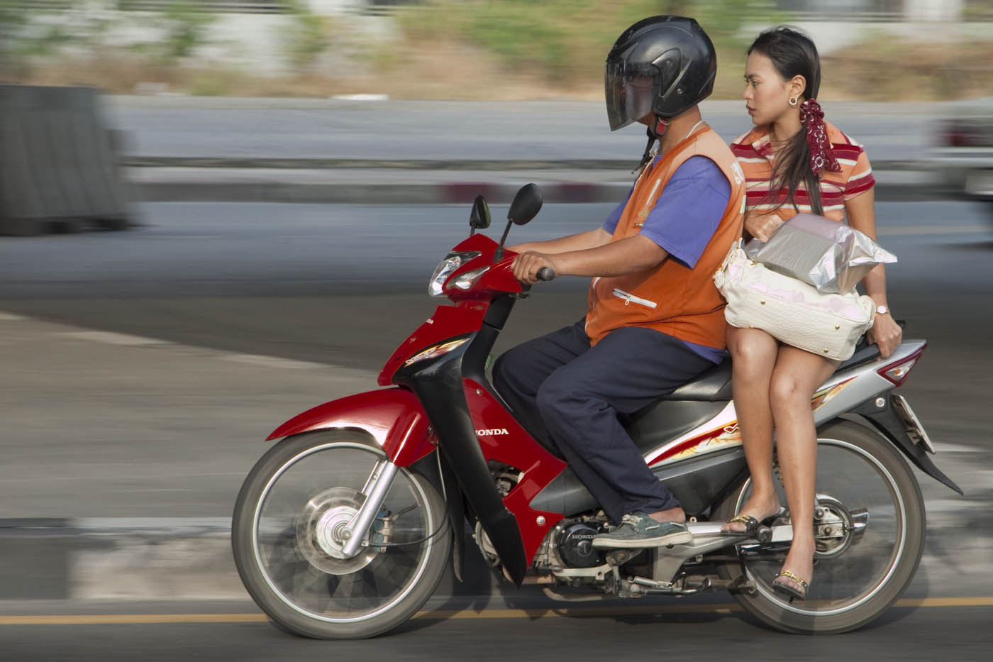 girl returns from shopping on Bangkok motorcycle taxi